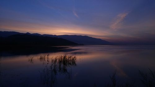 Scenic view of lake against sky during sunset