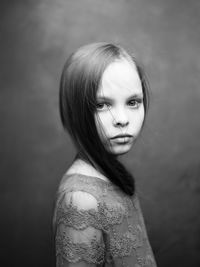 Portrait of woman standing against wall