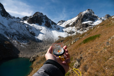 Low section of woman sitting on mountain