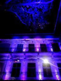 Low angle view of illuminated building at night