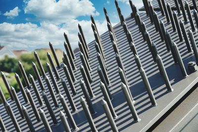 Row of metal fence against sky