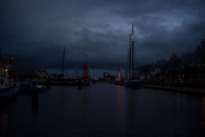 Sailboats in sea against sky at dusk