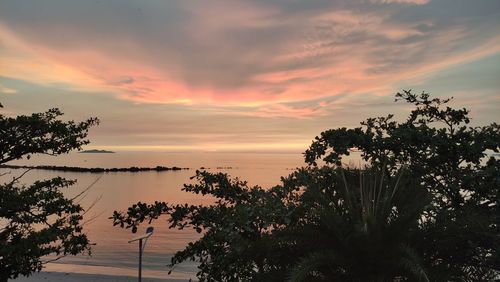 Scenic view of lake against orange sky