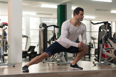 Muscular man exercising in gym