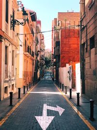 Empty alley amidst buildings in city