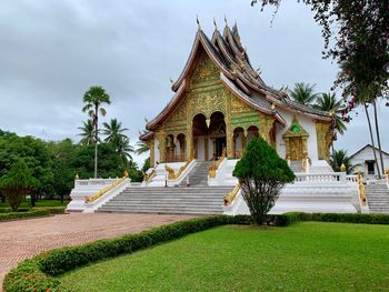 Temple by building against sky