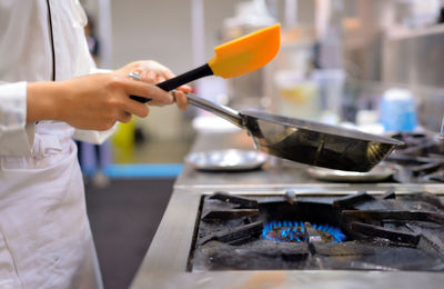 Midsection of man preparing food