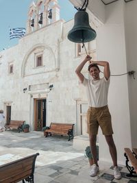 Full length of man standing against built structure