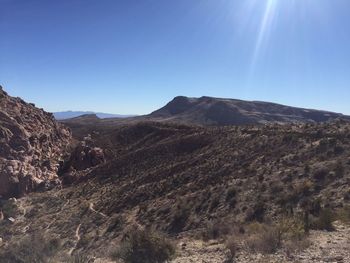 Scenic view of mountains against clear blue sky