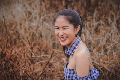 Portrait of smiling young woman on field