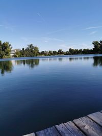 Scenic view of lake against blue sky