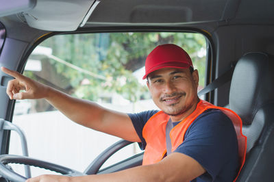 Portrait of smiling young man in car