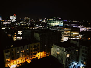 High angle view of illuminated buildings in city at night