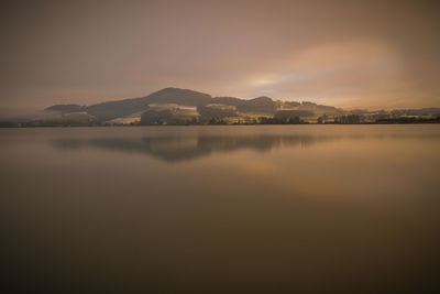 Scenic view of mountains against sky at sunset