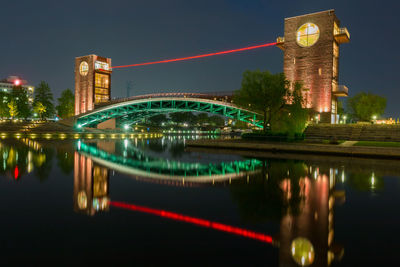 Reflection of illuminated buildings in city at night