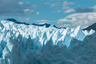 Snow covered landscape against sky