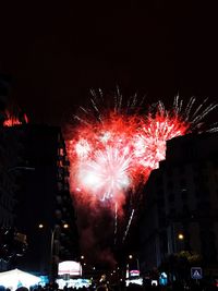 Low angle view of firework display at night