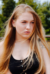 Close-up of young woman with long hair looking away 