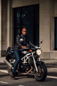 Portrait of mid adult man sitting on motorcycle