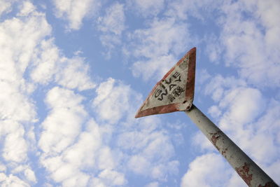 Low angle view of road sign against sky