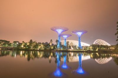 Reflection of illuminated buildings in lake at dusk