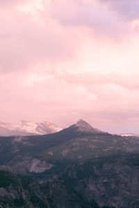 Scenic view of mountains against cloudy sky