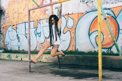 Woman with graffiti on wall