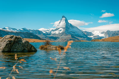 Scenic view of snowcapped mountains against sky