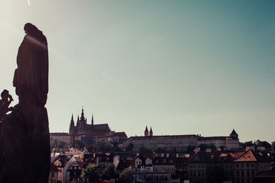 Buildings in town against clear sky