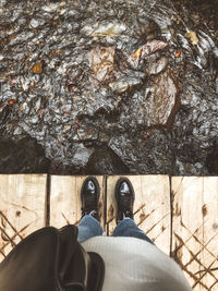 Low section of man standing on rock