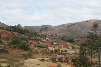 High angle view of townscape by mountain against sky