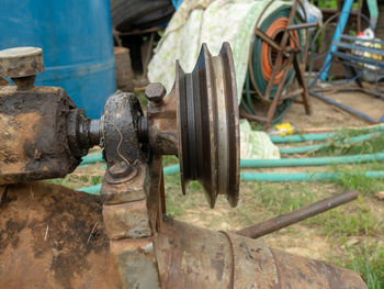 Close-up of old machinery on field