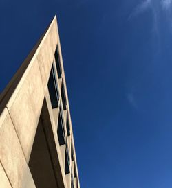 Low angle view of modern building against clear blue sky