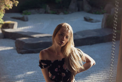 Portrait of smiling young woman standing outdoors