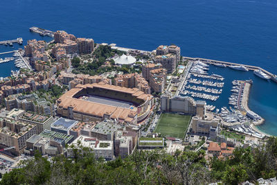 High angle view of townscape by sea against city