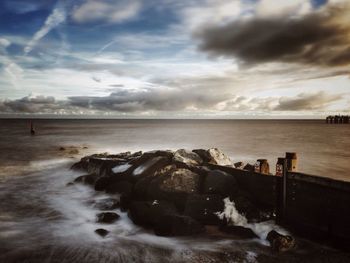 Scenic view of sea against cloudy sky