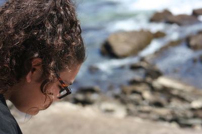 Side view of young woman in sunglasses