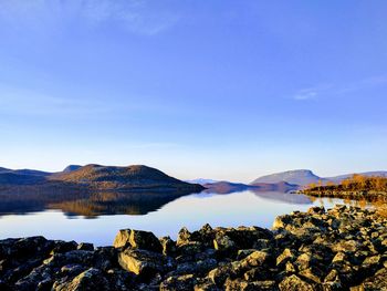 Scenic view of mountains against clear blue sky