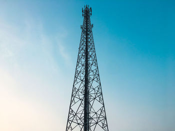 Low angle view of communications tower against sky