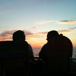 Silhouette of people on beach at sunset