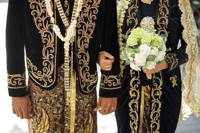 Midsection of woman wearing traditional clothing