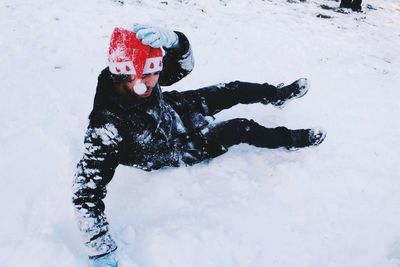 High angle view of man wearing santa hat on snowy field during winter