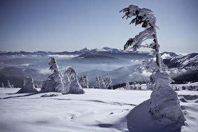 Scenic view of snowcapped mountains against sky during sunset