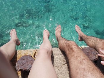Low section of people relaxing in sea