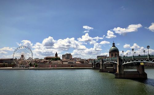 Bridge over river with buildings in background