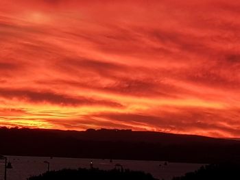 Scenic view of dramatic sky over silhouette landscape