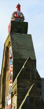 Low angle view of flag on building against sky