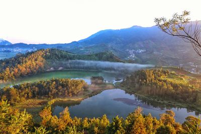 Scenic view of lake and mountains against sky