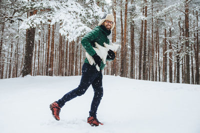 Full length of man standing on snow covered land