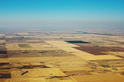 Scenic view of agricultural field against clear sky
